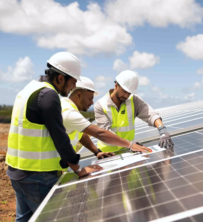 Engineers reviewing plans on a solar installation